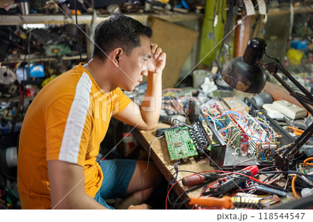 moody repairmen experience difficulties when repairing electronic devices on the workbench moody repairmen experience difficulties when repairing electronic devices on the workbench 118544547