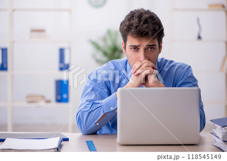 Young male employee working in the office Young male employee working in the office 118545149