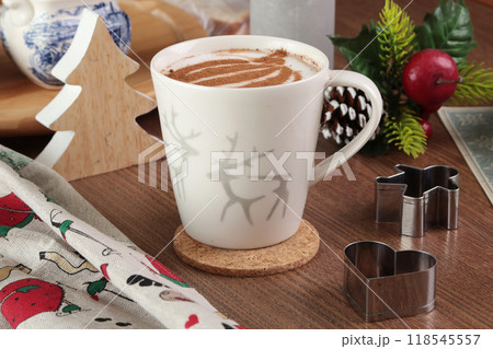 Ceramic cappuccino cup and table decor. Christmas festivities. Background for design. Ceramic cappuccino cup and table decor. Christmas festivities. Background for design. 118545557