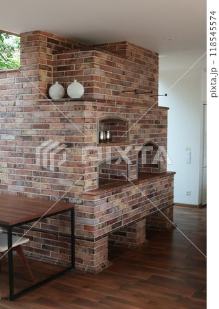 Modern brick oven in large house. Interior in living room. Kitchen and cooking. Lifestyle and furniture.  118545574