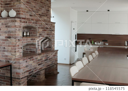 Modern brick oven in large house. Interior in living room. Kitchen and cooking. Lifestyle and furniture.  118545575