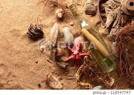 Message in a vintage bottle on a sea shore. Message in a vintage bottle on a sea shore. 118547747