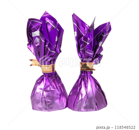 Chocolate sweets in violet foil isolated on the white Chocolate sweets in violet foil isolated on the white 118548522