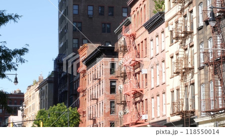 New York City building architecture, Manhattan. Residential house exterior. Red brick, fire escape. 118550014