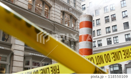 Steam vapor vented, New York City street steam system, orange vapour tube stack. Hot smoke from pipe 118550109
