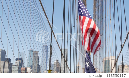 American flag on Brooklyn Bridge to Manhattan, New York City. Patriotic symbol. Travel USA. American flag on Brooklyn Bridge to Manhattan, New York City. Patriotic symbol. Travel USA. 118550117
