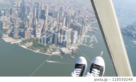New York City doors off helicopter flight, Manhattan USA. Feet in sneakers, legs in shoes selfie pov New York City doors off helicopter flight, Manhattan USA. Feet in sneakers, legs in shoes selfie pov 118550249