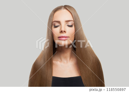 Lovely woman with long healthy straight shiny hairstyle, make-up and fresh skin posing Lovely woman with long healthy straight shiny hairstyle, make-up and fresh skin posing 118550897