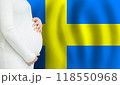 Swedish pregnant woman belly against Swedish flag background. Demographics and pregnancy  118550968