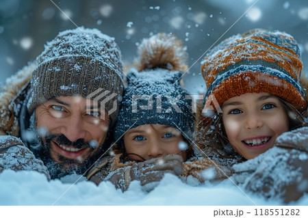 A family enjoying a snow day together. 118551282