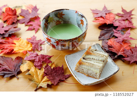 Cup of fresh matcha tea, green tea and banana cake on wooden table. 118552027
