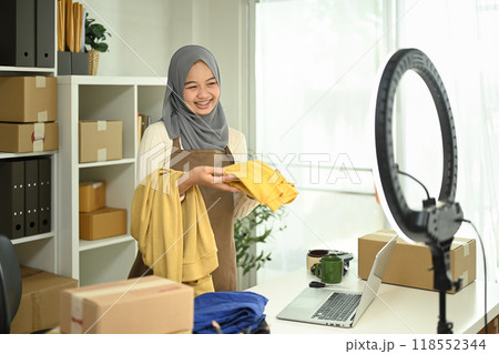 Young Muslim woman with hijab working live streaming to sell products. E-commerce and small business concept 118552344