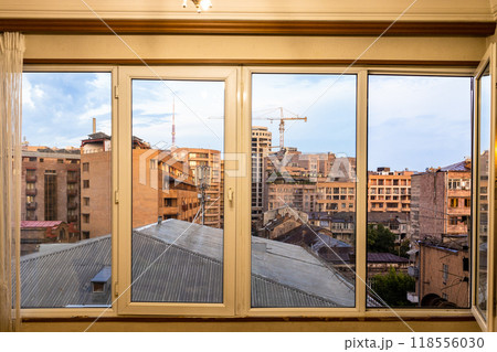 view through windows of city houses in evening 118556030
