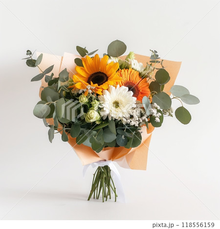 Vibrant bouquet of sunflowers, daisies, orange gerberas, and eucalyptus wrapped in paper, standing 118556159