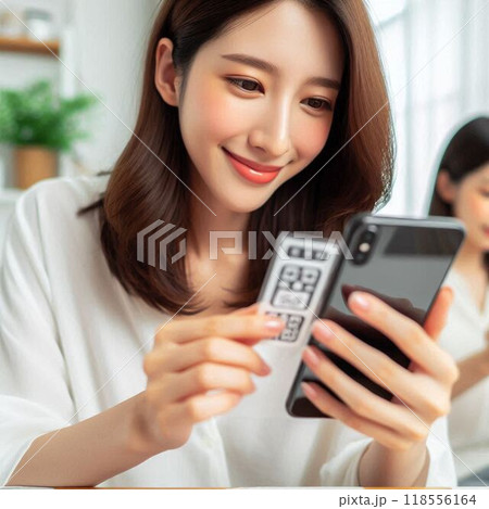 スマートフォンの画面を保護しようと説明書をみる女性 118556164