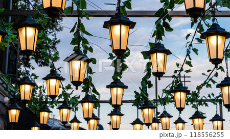 many electric street lanterns in summer twilight 118556255