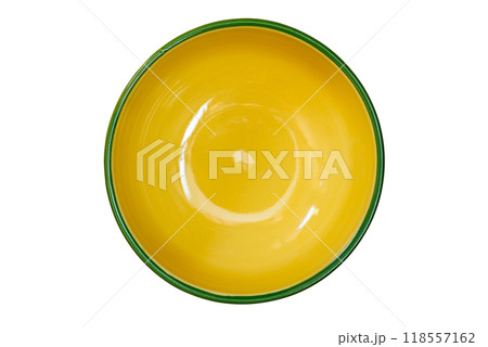 Top view of empty single yellow ceramic bowl with green edge. 118557162