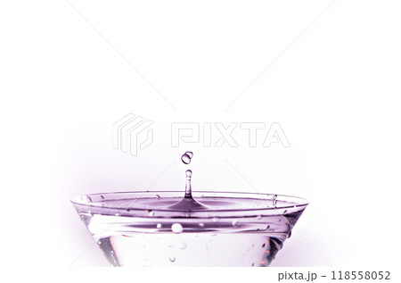 Close-up of water drop falling into a glass	 118558052