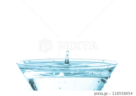 Close-up of water drop falling into a glass	 118558054
