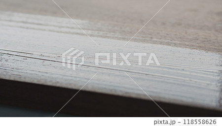 applying oil finish with brush to black walnut board 118558626