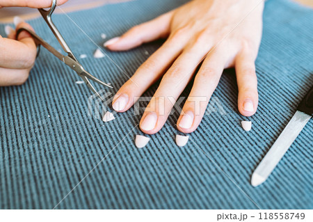 women's hands with manicure, one hand with trimmed nails women's hands with manicure, one hand with trimmed nails 118558749