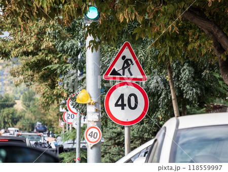 Road work traffic sign with a speed regulation signs in the city. High quality photo Road work traffic sign with a speed regulation signs in the city. High quality photo 118559997