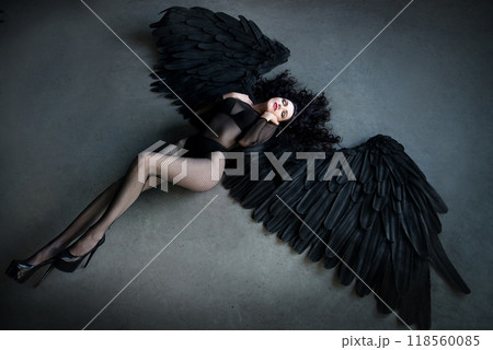 Fallen black angel with wings. 118560085