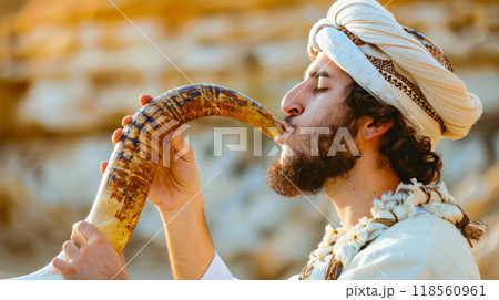Man blowing shofar in traditional jewish ceremony at sunset 118560961