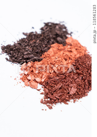 Scattered eye shadows in different shades. Cosmetics texture, white background. 118561283