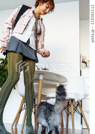 attractive extravagantly dressed young woman, student, schoolgirl with red curly hair with backpack in home interior attractive extravagantly dressed young woman, student, schoolgirl with red curly hair with backpack in home interior 118562112