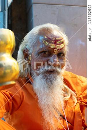 Ascetic monk Sadhu in India with beard, white hair and painted face preaching Ascetic monk Sadhu in India with beard, white hair and painted face preaching 118562993