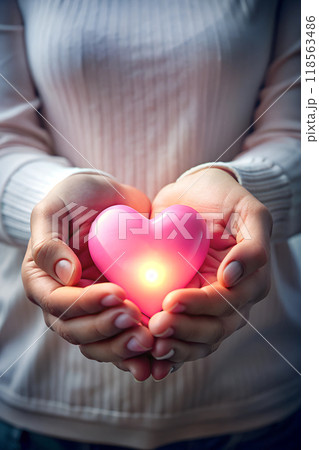 Hands Holding a Heart-Shaped Object Representing Charity and Care 118563486
