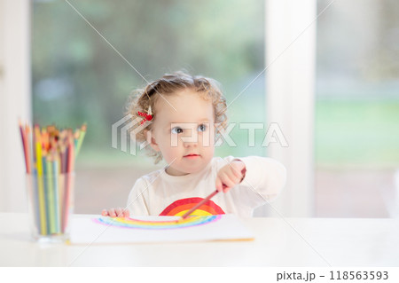 Kids paint. Child painting. Little girl drawing. 118563593