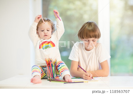 Kids paint. Child painting. Little girl drawing. 118563707
