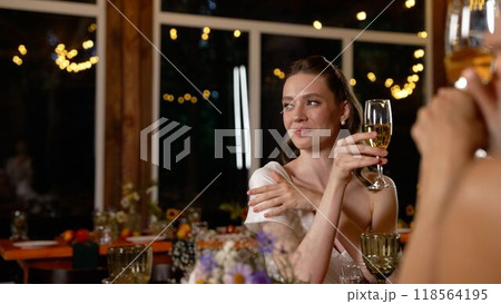 Friends celebrating with raised glasses at festive party. Friends celebrating with raised glasses at festive party. 118564195