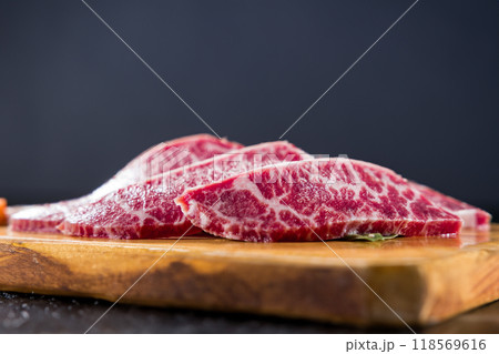 fresh raw beef sliced on wooden board close up shot fresh raw beef sliced on wooden board close up shot 118569616