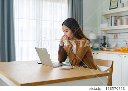 Asian young woman seriously working on computer laptop in house 118570828
