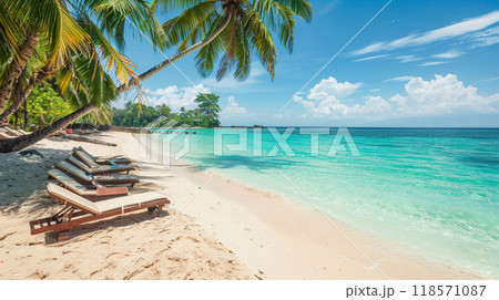 Idyllic beach scene featuring sun loungers under palm trees, inviting relaxation 118571087