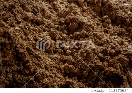 Large pile of earth in which there are many metal reinforcement bars Large pile of earth in which there are many metal reinforcement bars 118573684