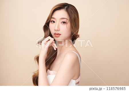Beautiful young asian woman with clean fresh skin on beige background, Face care, Facial treatment, Cosmetology, beauty and spa, Asian women portrait. 118576985