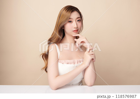 Beautiful young asian woman with clean fresh skin on beige background, Face care, Facial treatment, Cosmetology, beauty and spa, Asian women portrait. 118576987