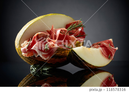 Prosciutto with melon and rosemary. Prosciutto with melon and rosemary. 118578316