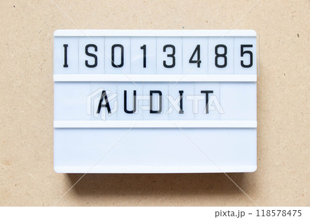Lightbox with word ISO13486 audit on wood background Lightbox with word ISO13486 audit on wood background 118578475
