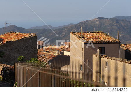 Rustic village rooftops with mountain and coastal views Rustic village rooftops with mountain and coastal views 118584232