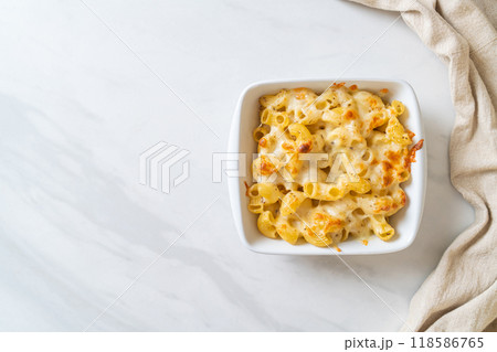 American mac and cheese, macaroni pasta in cheesy sauce American mac and cheese, macaroni pasta in cheesy sauce 118586765
