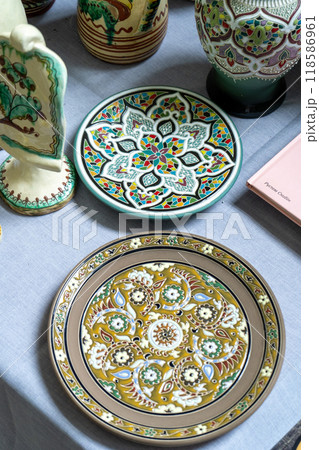 Plates on the table. Classic Crimean Tatar painted dishes. Ceramics Plates on the table. Classic Crimean Tatar painted dishes. Ceramics 118586961