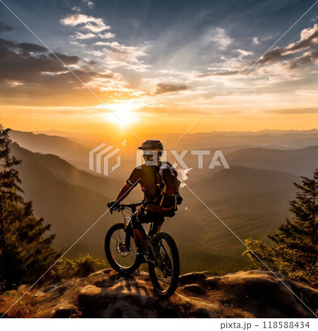 Mountain biker enjoying sunset view over scenic mountain landscape 118588434