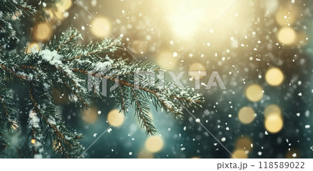 Snow-covered pine branch with blurred festive lights and snowflakes falling gently 118589022