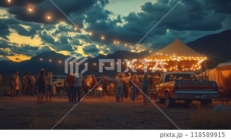 People gather around a tent with string lights hanging 118589915