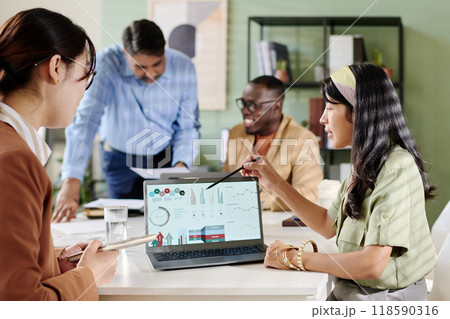 Collaborating in Modern Office with Diverse Team Members 118590316